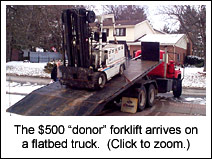 The $500 donor forklift arrives by truck.