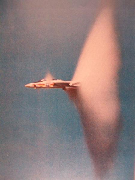 Military pilots routinely punch through the sound barrier as shown here with US NAVY Tomcat.Condensation clouds form as heat of compression is liberated during pressure collapse behind shockwaves