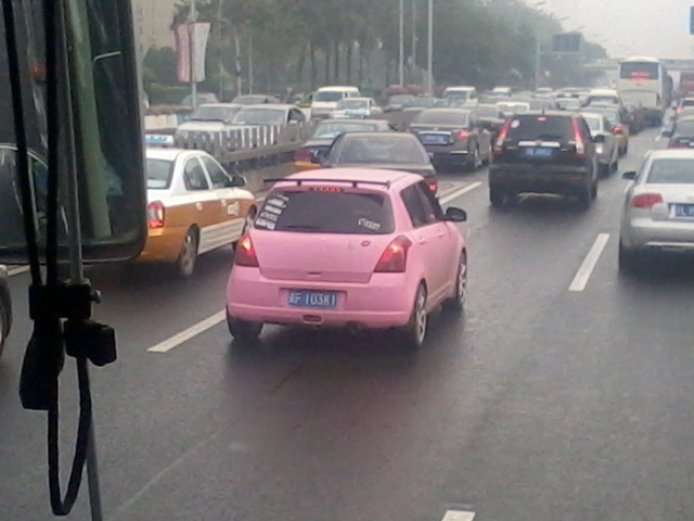 Pink racer with a kiss on hatch  - Beijing City traffic jam.