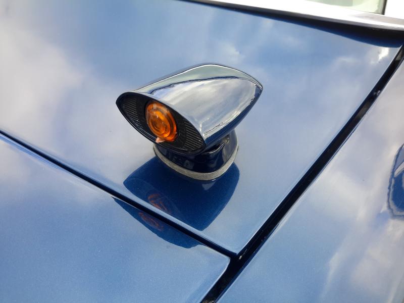 A headlight detecting sensor on the front driverside hood of a late 60's Lincoln Continental. It detects oncoming headlights and switches the Lincoln's headlights to low beam automatically.