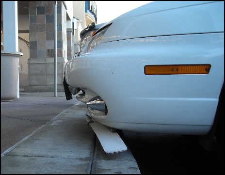 Air Dam in horizontal (non-deployed) position over low curb.