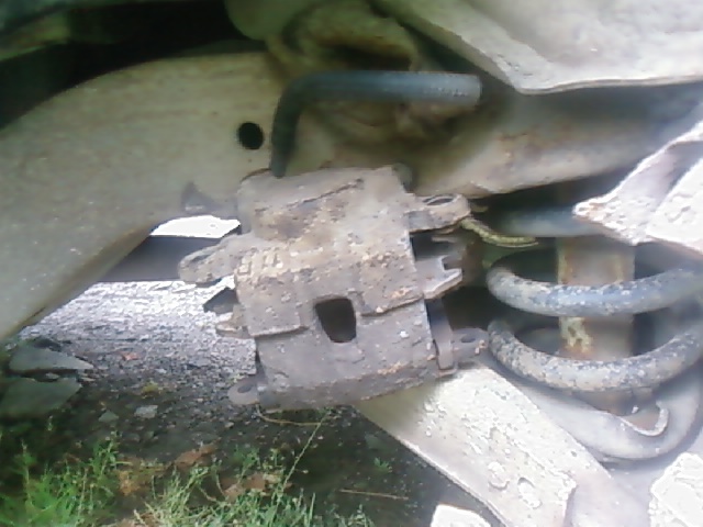 Hang the caliper up, don't leave it hang on the brake line.