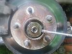 Remove wheel bearing retaining washer