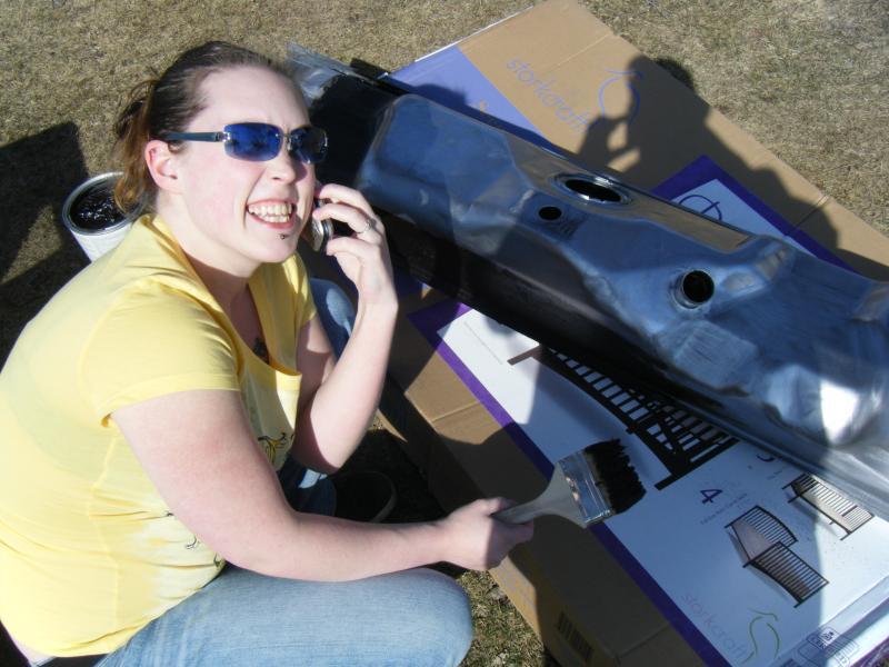 Wife painting the tank with roof cement