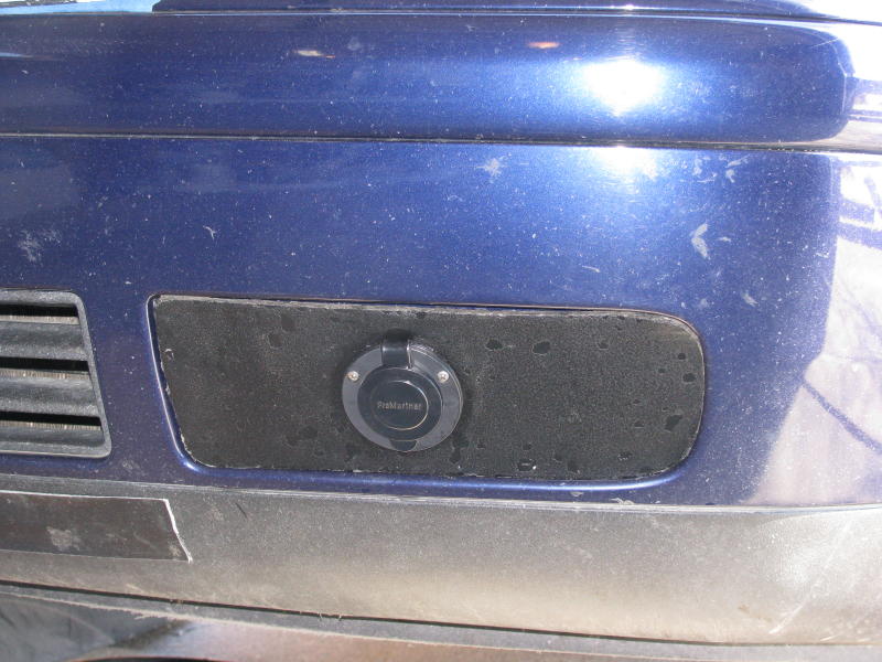 Waterproof plug holder for coolant heater installed in the left bumper grill