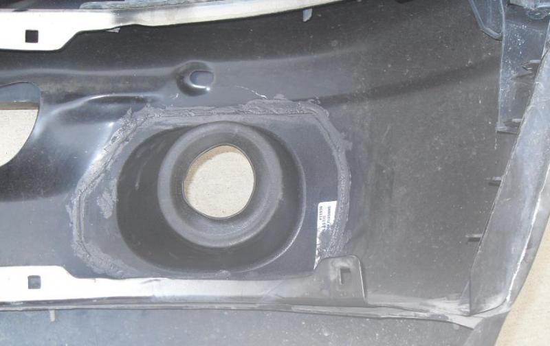 View from the back side of the bumper (with it off the truck).  This is a plastic and rubber "boot" that's used in construction for when you send a pipe out the roof.  I cut down the edges and used RTV silicon to stick it on the back of the fog lamp hole.