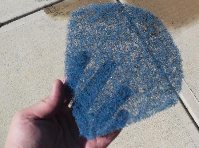 I used this as a "pre-filter" to catch any insects and pieces of debris that might find their way in.  It's a piece of an old washable furnace filter that I had lying around.  It's a plastic mesh.