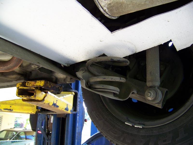 Rear aero mod view from a car lift. Notice how the leading part of the plastic is inside the C beam of the axle. It will never fall and the incoming air will not affect it.