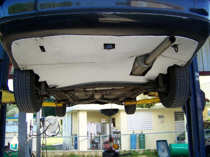 Rear aero mod view from a car lift.