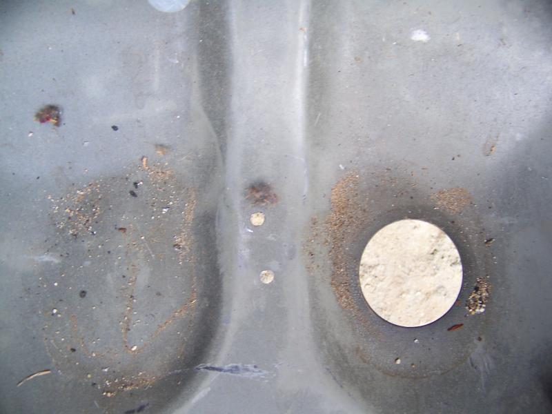 The only perforations made to the steel of the car, located in the spare tire well. It is used to pass a tie rap to hold the corrugated plastic.