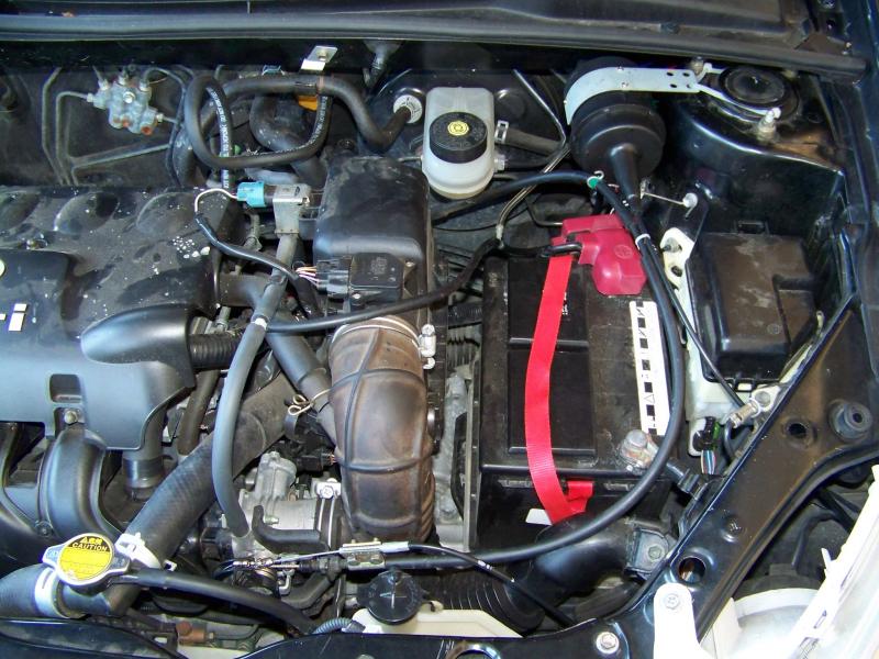 Engine bay area view of the cruise control.