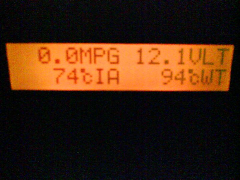 The Scan Gauge II displaying miles per gallon (MPG), volts (VLT), intake air temperature (cIA) and coolant temperature (cWT). Both temp readings are in Celsius.  

This readout was made at about 8 PM on a summer night in Puerto Rico with the car idling and not moving, that's why MPG=0. 

The ambient temperature was 28 Celsius, measured with a lab thermometer. So there is a delta Temp of 46 Celsius. 

That is a change in temperature from 28 to 74, an increment of 164%