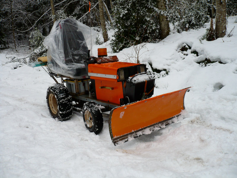 Elec-trak with plow attachment.