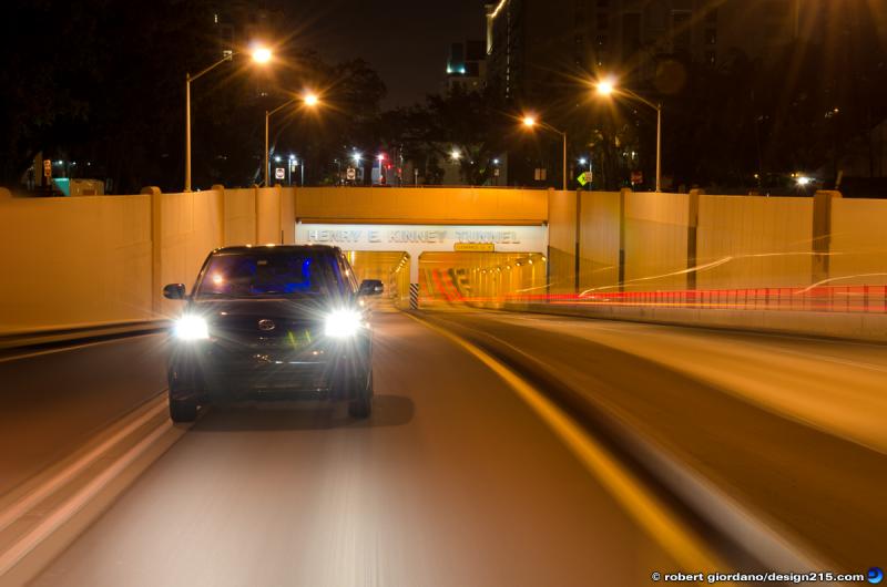 This is a photo of me driving my Scion xD. The thing is, I also took the photo. Here are some facts about this photo:
1) This is NOT a composite or collage of multiple images, put together in Photoshop. 
2) I was driving the car when the photo was taken.
3) There was other traffic in the tunnel. 
4) I took the photo. No one else touched my camera.
5) There is only one vehicular tunnel in the state of Florida, and its in Fort Lauderdale.