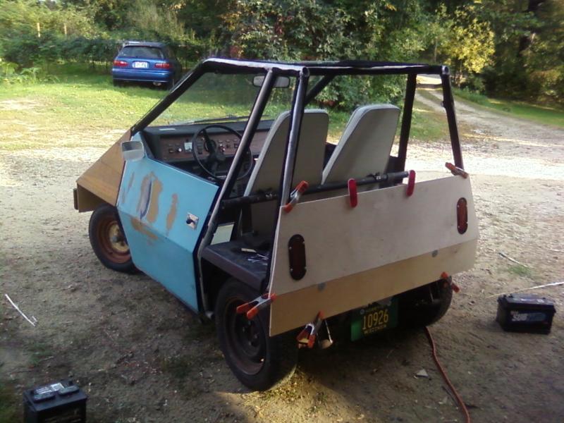 Drivers side rear, rear end held on with clamps instead of the bolts, this is pre-epoxy/fiberglass, front fender is half done, tail lights are LED.