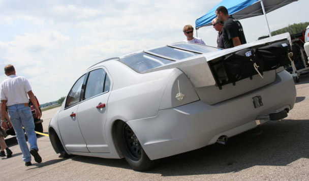 Land Speed Racer Ford Fusion with spoiler. Flat spoiler extends horizontally backward to intersect the theoretical "streamlining template", using the cushion of air behind the rear window as a virtual kammback.